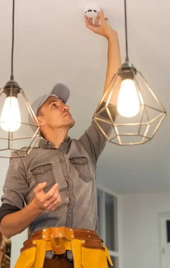 Electrician installing a pendant light fixture